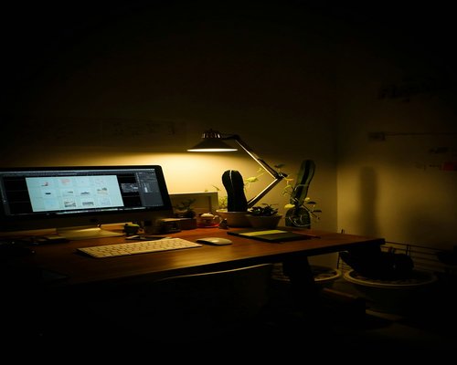 Well lit workspace with desk lamp and window light